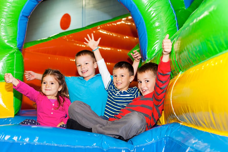 kids jumping in a colorful bounce house